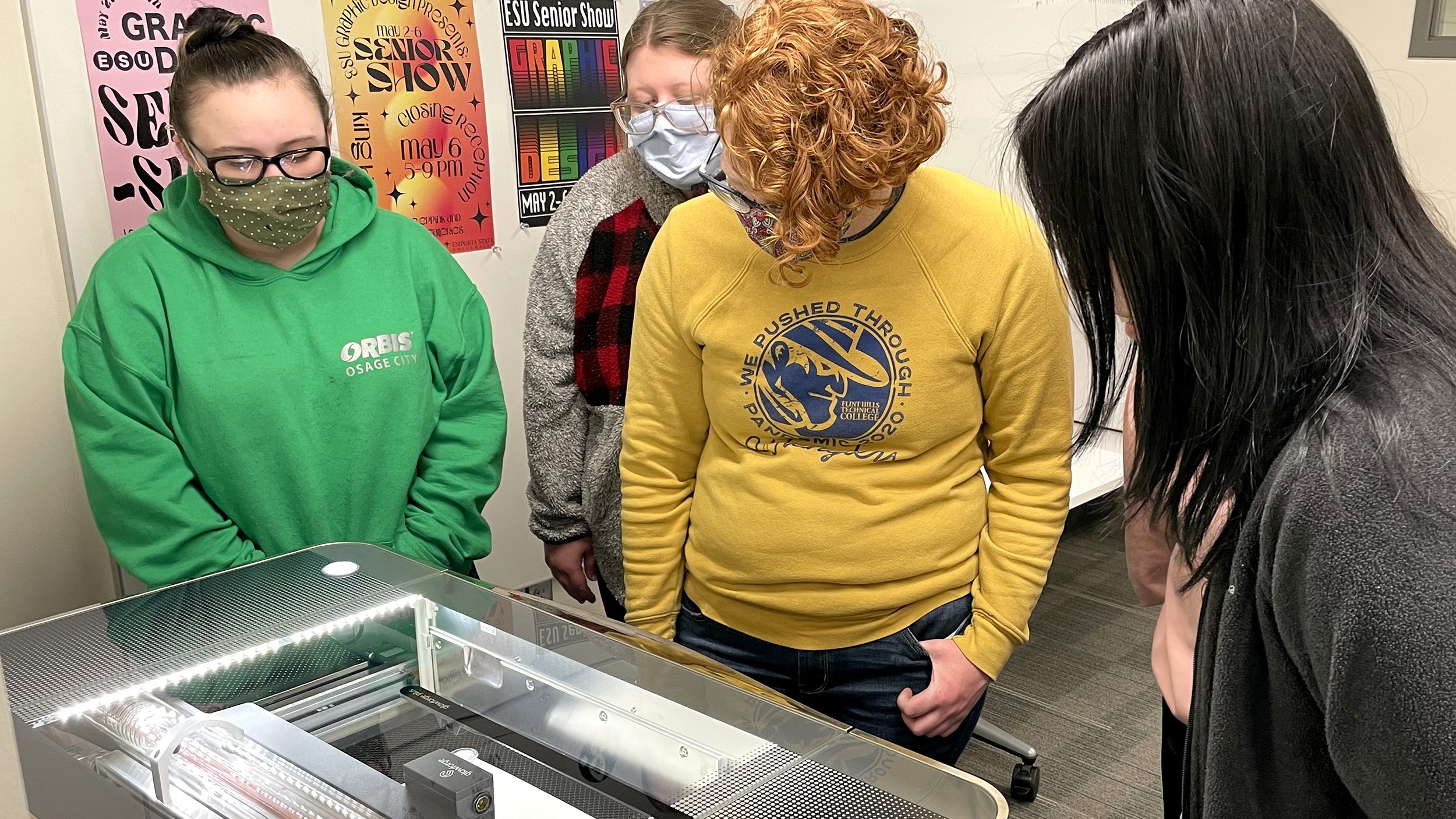 4 students watching a Glow Forge